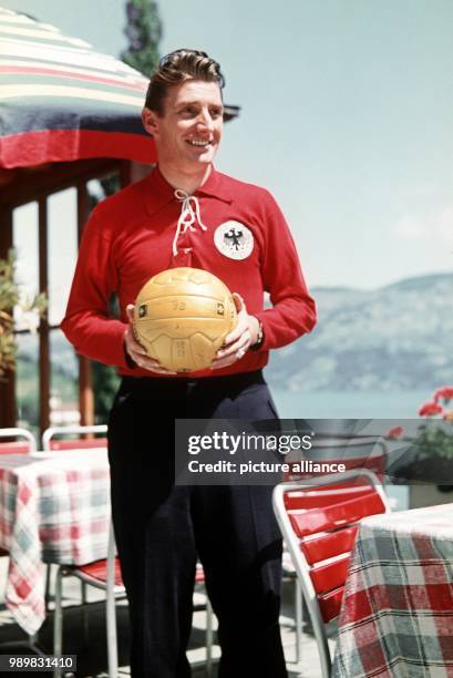 German soccer player Fritz Walter wears a sweat suit and holds a soccer ball in his hands, Germany, 1954. The famous sports idol played for the 1st...