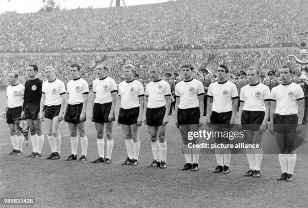 The German national team assembles on the pitch of Niedersachsen Stadium for the playing of the national anthems on 23 June 1966 prior to an...