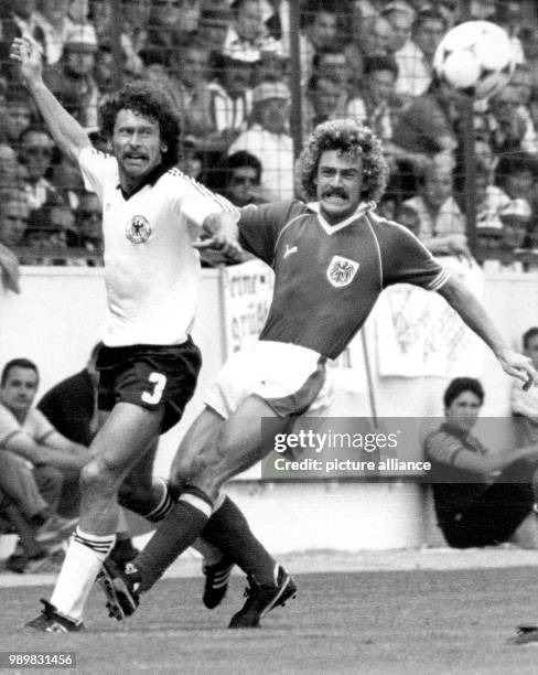 German midfielder Paul Breitner gets the better of Austrian forward Walter Schachner in a struggle for the ball during the 1982 World Cup group game...