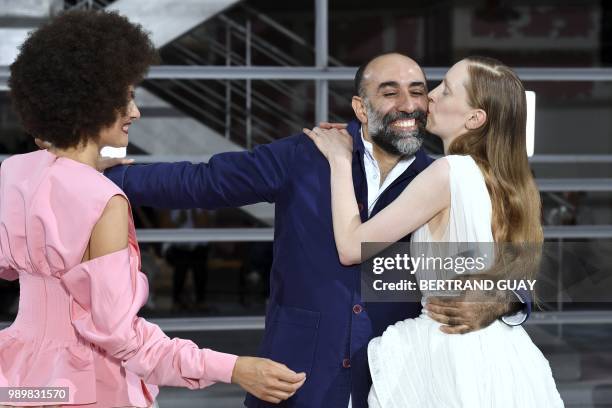 Model kisses Lebanon fashion designer Rabih Kayrouz as he acknowledges the audience at the end of his 2018-2019 Fall/Winter Haute Couture collection...