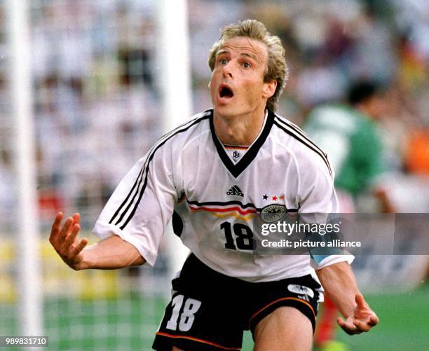 German forward and team captain Juergen Klinsmann cheers after scoring 1-1 equalizer during the 1998 World Cup second round game against Mexico at...