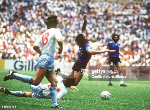 Argentina's star forward Diego Maradona is fouled by an opposing English player and falls to the ground. The Argentinian national team advanced to...