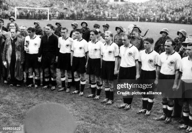 German national soccer team players stand in file as they are honoured as the World Champions after Germany beat Hungary in the 1954 World Cup final...