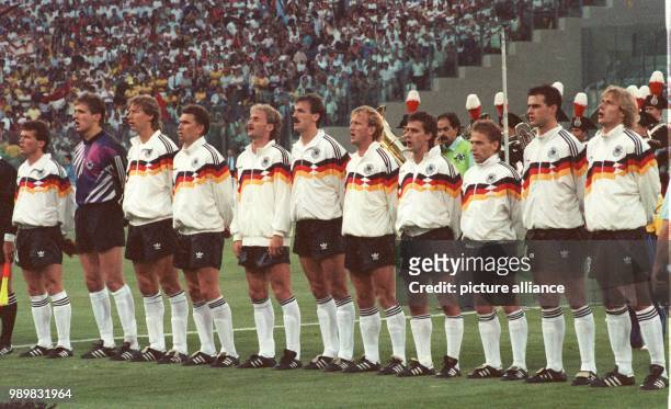 The players of the German national team stand in file for the national anthem prior to the 1990 World Cup final against Argentina in Olympic Stadium...
