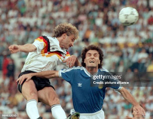 German forward Rudi Voeller and his Argentinean opponent Oscar Ruggeri are fighting for the ball. The German national team wins the World Cup final...