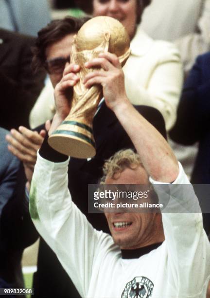 Jubilant Berti Vogts raises the Fifa World Cup trophy in the air. After numerous dramatic situations and great pressure from the dutch team in the...
