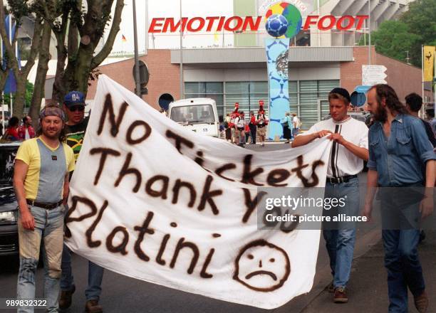 German soccer fans unfold a banner with the inscription "No tickets - thank you, Platini" in front of the Stade Felix Bollaert in Lens, France on 21...