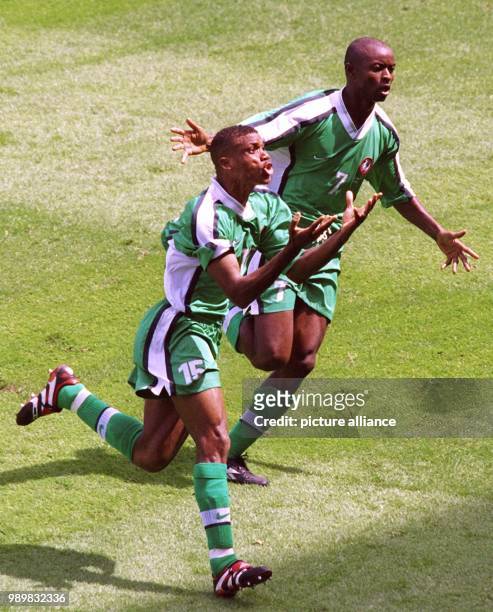 Nigerian midfielder Sunday Oliseh jubilates together with his team-mate Finidi George after scoring the 3-2 against Spain. The goal will turn out to...