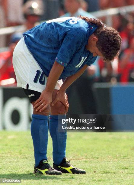 Italian midfielder Roberto Baggio rests his hands on his knees in disappointment after missing the goal in the penalty shoot out in the final of the...