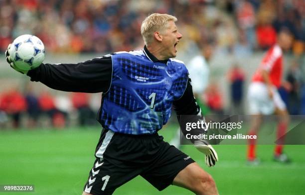 Danish goalkeeper Peter Schmeichel shouts instructions towards his teammates while he is about to throw the ball back into the game during the 1998...