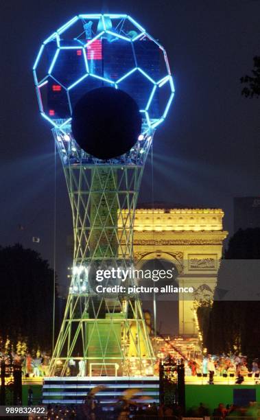 The famous obelisk at the Place de la Concorde stands disguised as the World Cup by a large framework, which gives a taste of the upcoming "Fete du...