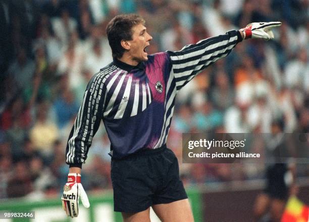 German goalkeeper Bodo Illgner shouts instructions at his teammates and emphasises these with wild gestures. The German national soccer team wins...