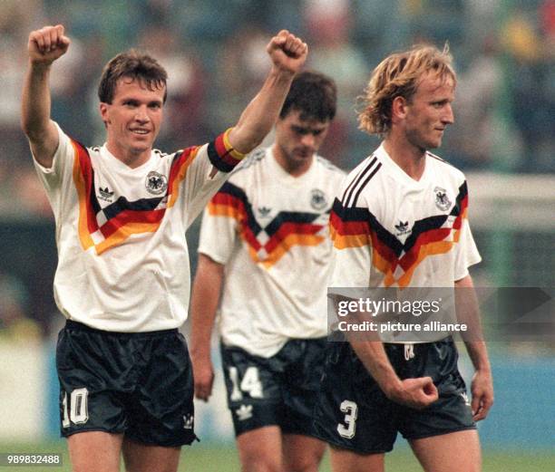 German midfielder and team captain Lothar Matthaeus jubilates and victoriously gestures with his stretched arms and fists while he walks off the...