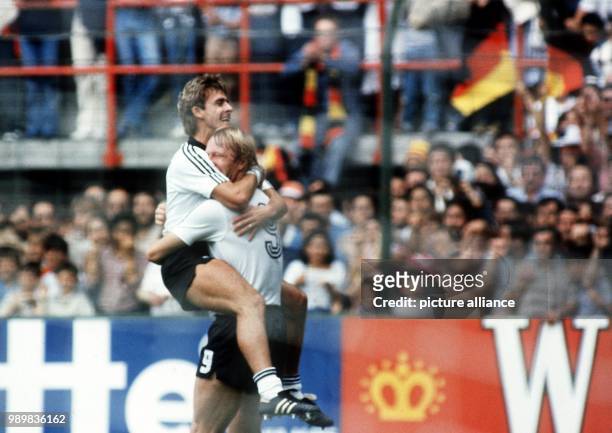German forward Pierre Littbarski hugs Horst Hrubesch after the latter has just scored a goal. The German side scores an early 1-0 lead in the first...