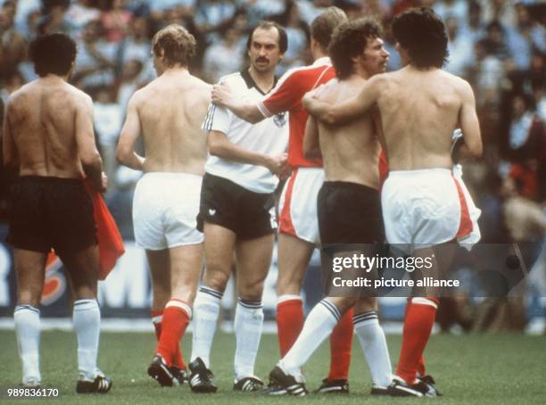 Friendly hugs and handshakes after the match mark a shameful collusive game: German midfielder Paul Breitner is hugged by a teammate while sweeper...