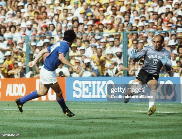 Italian forward Paolo Rossi suddenly finds himself alone in front of Brazilian goalkeeper Valdir Peres who can clear the attack. The Italian national...