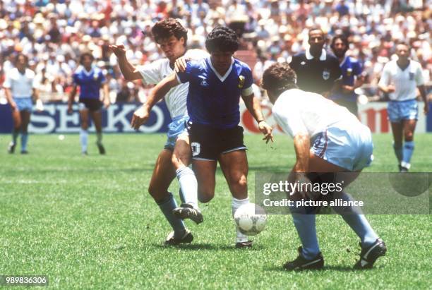 English defenders Terry Fenwick and Kenny Sansom try to stop Argentinian ace midfielder and goalgetter Diego Maradona. On the way to the title the...