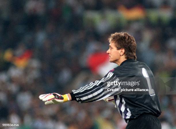 Cologne's Bodo Illgner guards the German goal on 8 July 1990 during the World Cup final at the Olympic Stadium in Rome, Italy and holds his opponents...