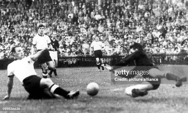 German forward Max Morlock scores the 1-2 goal follow-up for Germany while Hungarian goalkeeper Gyula Grosics fails in his attempt to stop him and...