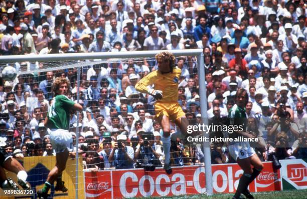 German goalkeeper Harald Schumacher misses a cross while Argentinian defender Jose Luis Brown is able to use his chance and to score the 1-0 goal...