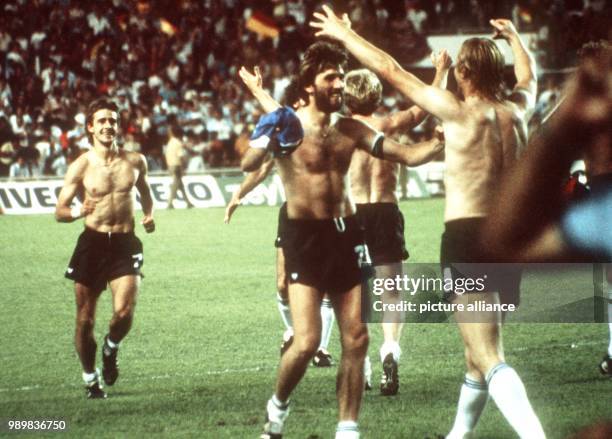 German defender Manfred Kaltz cheers and walks towards jubilating German forward Horst Hrubesch after he scored a salvific penalty kick while...
