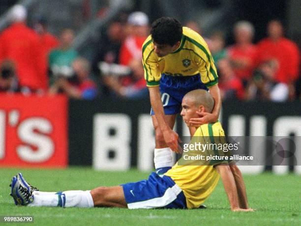 Brazilian forward Bebeto comforts his teammate Ronaldo after the 1998 World Cup final France against Brazil at the Stade de France in Saint Denis,...
