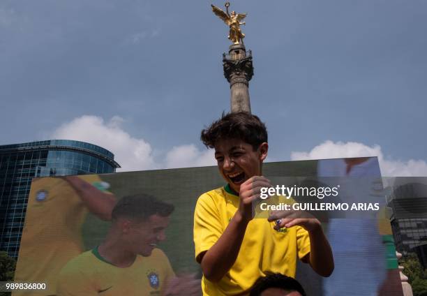 Fan of Brazil celebrates after watching the World Cup football match between Mexico and Brazil in a public event at the Angel de la Independencia...