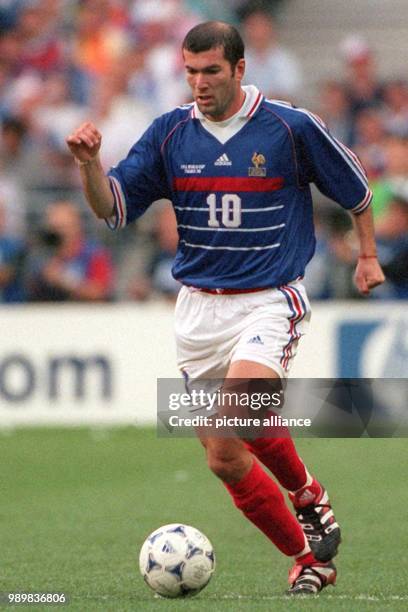 French forward Zinedine Zidane controls the ball during the 1998 World Cup final France against titleholder Brazil at the Stade de France in Saint...