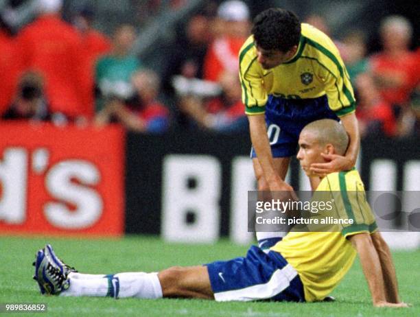 Brazilian forward Bebeto comforts his teammate Ronaldo after the 1998 World Cup final Brazil against France at theStade de France in Saint Denis,...