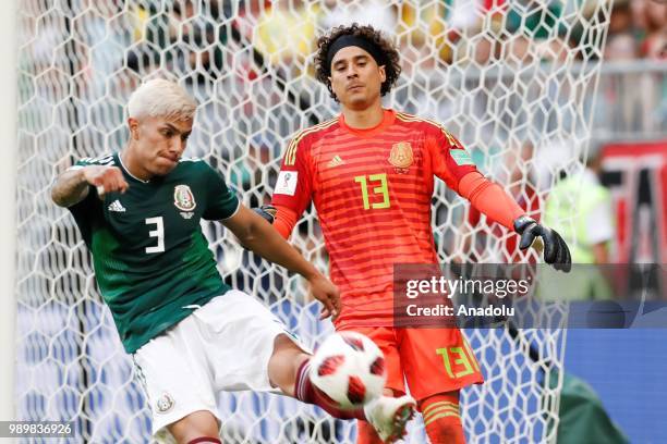 Carlos Salcedo of Mexico kicks the ball away next to his team's goalkeeper Guillermo Ochoa during the 2018 FIFA World Cup Russia Round of 16 match...