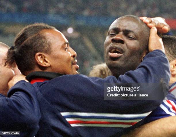 French substitute goalkeeper Bernard Lama embraces French two-fold goal scorer Lilian Thuram after the 1998 World Cup semifinal France against...