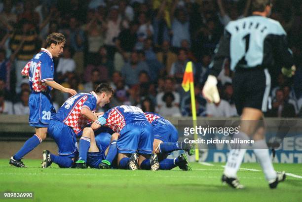 Kroatian players group around each other on the pitch with joy, cheer and jubilate after the Croatia scored the 3-0 goal during the 1998 World Cup...