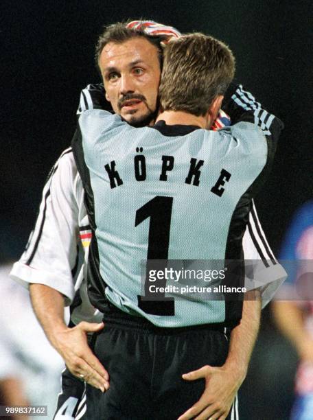 German goalkeeper Andreas Koepke and Juergen Kohler look disappointed and embrace each other in mutual comfort after the 1998 World Cup quarter final...