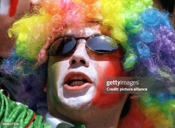 Mexican supporter cheers for his team wearing a colourful wig and a painted face during the 1998 World Cup second round game Germany against Mexio in...