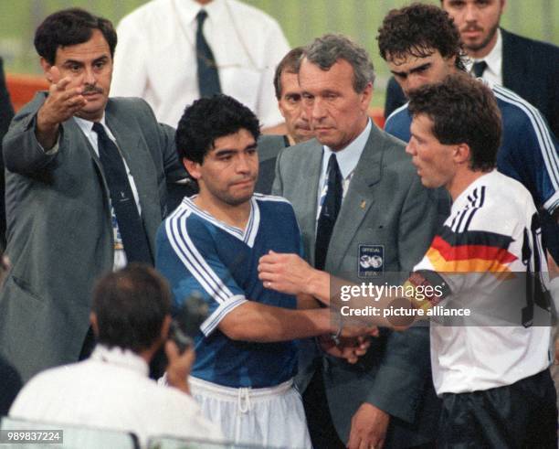 Lothar Matthaeus , captain of the German national soccer team, shakes hands with his Argentinian counterpart Diego Maradona and has some words of...