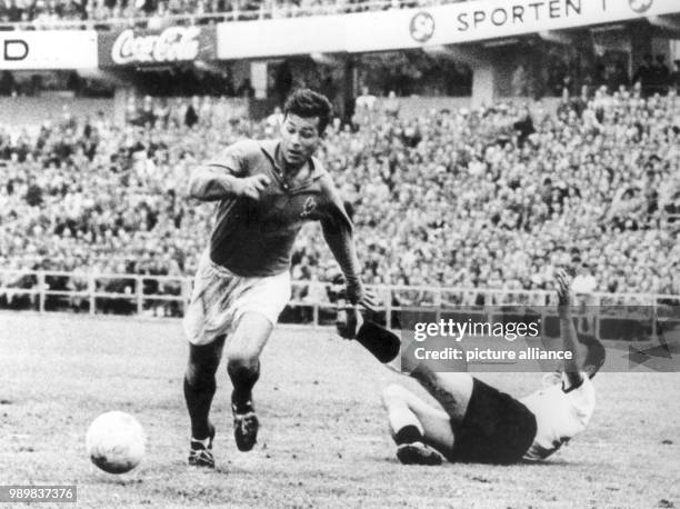 French forward Just Fontaine dribbles past falling German player Alfred Kelbassa and storms towards the German goal. Fontaine scored three goals in...