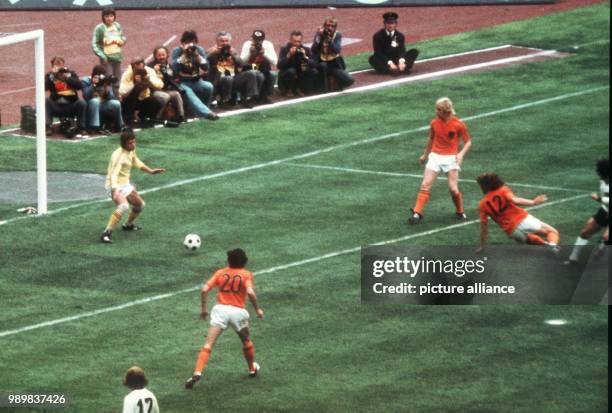 German forward Gerd Mueller pushes the ball past defender Ruud Krol and goalkeeper Jan Jongbloed into the Dutch goal for the decisive 2-1 goal during...