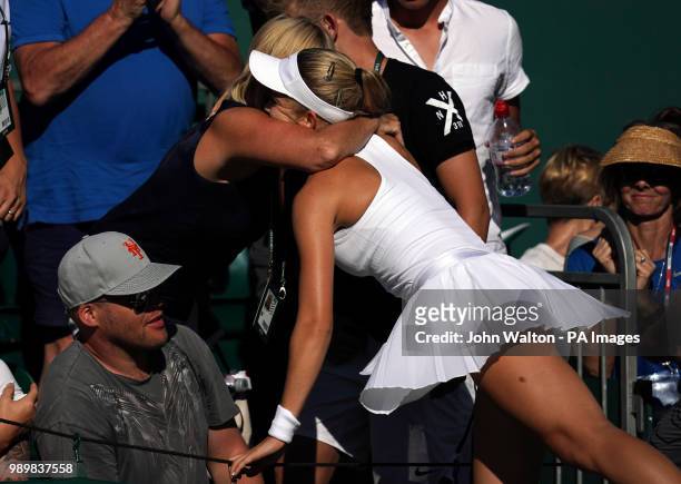 Katie Swan celebrates victory over Irina-Camelia Begu with family members on day one of the Wimbledon Championships at the All England Lawn Tennis...
