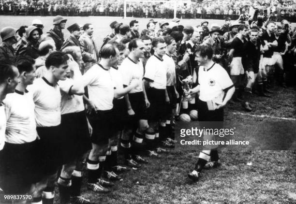Fritz Walter , the German team captain, presents the Jules Rimet Cup during the award ceremony after Germany defeated Hungary in the 1954 World Cup...