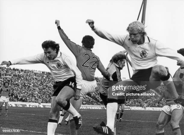 German players Dieter Mueller and Rolf Ruessmann seem to conduct a soccer ballet with Dutch goalkeeper Piet Schrijvers and his defender Ernie Brandts...