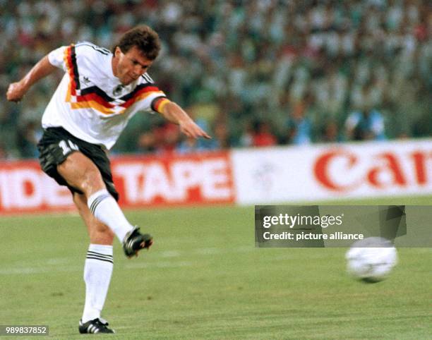 German midfielder and team captain Lothar Matthaeus kicks the ball acrosss the field during the 1990 World Cup final Germany against Argentina in...