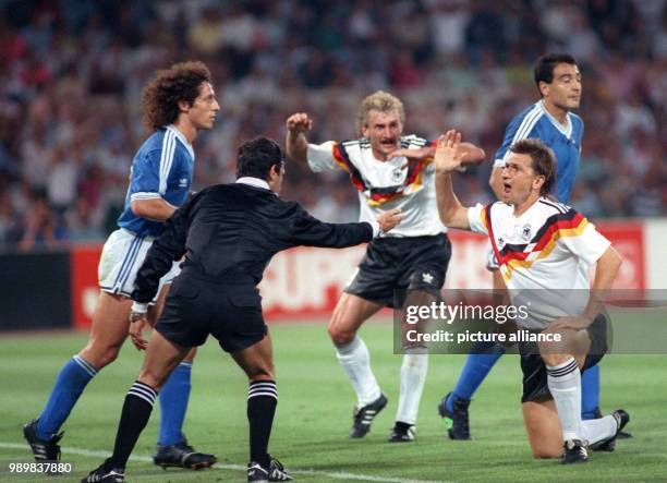 "Play On!" signals Mexican referee Edgardo Codesal Mendez despite protests from German players Rudi Voeller and Klaus Augenthaler . Argentineans...