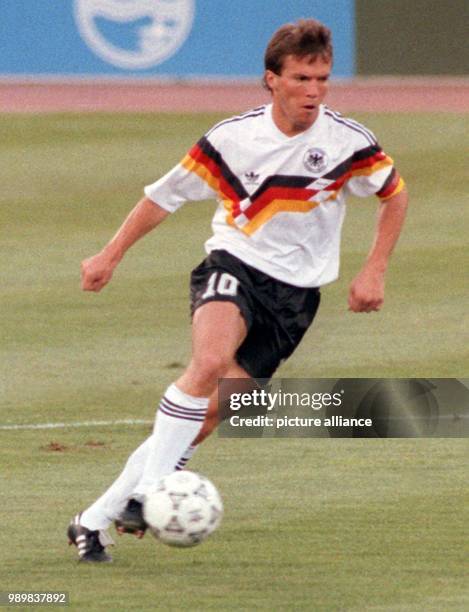 German midfielder and team captain Lothar Matthaeus dribbles the ball during the final FIFA World Cup 1990 soccer game Germany against Argentina in...