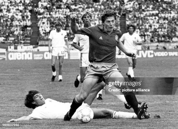 Spanish forward Emilio Butragueno gets the best of his Belgian opponent Georges Grun . The Spanish national team loses their World Cup quarter-final...