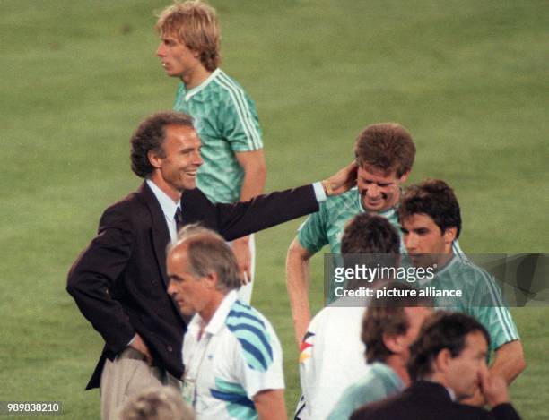German head coach Franz Beckenbauer sends his players Juergen Klinsmann , Stefan Reuter and Karlheinz Riedle back onto the pitch for the extra time...