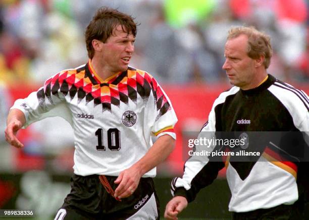 Record player Lothar Matthaeus and coach Berti Vogs are talking during half time of the 1994 FIFA World Cup last sixteen round match against Belgium...