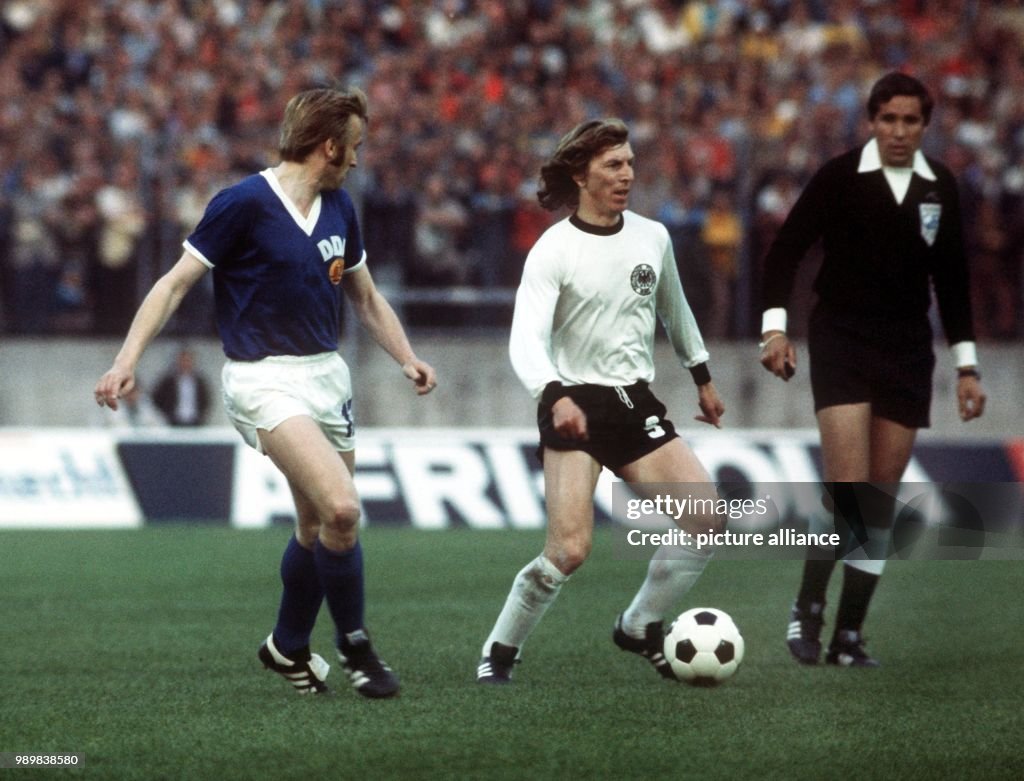 West German Forward Juergen Grabowski Has The Ball While East German west-german-forward-juergen-grabowski-has-the-ball-while-east-german