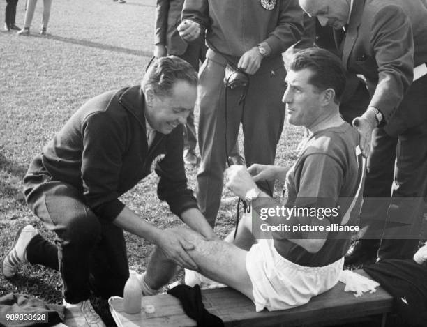 Fritz Walter is being prepared by massager Erich Deuser prior to the B-game Switzerland - Germany during the 1962 FIFA World Cup in Santiago de Chile...