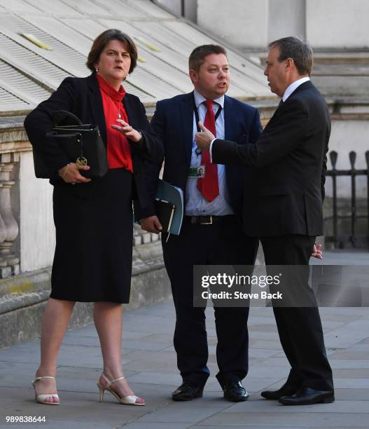 Leader of the Democratic Unionist Party Nigel Dodds and First Minister of Northern Ireland Arlene Foster with DUP Timothy Johnson after speaking to...