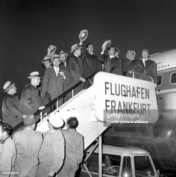 Team coach Sepp Herberger with players and assistants prior to their departure from Frankfurt Airport on their way to the 1962 FIFA World Cup in...